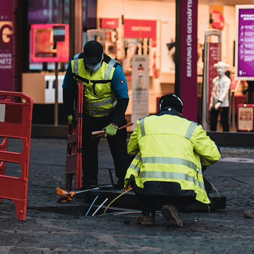 Road workers installing fiber